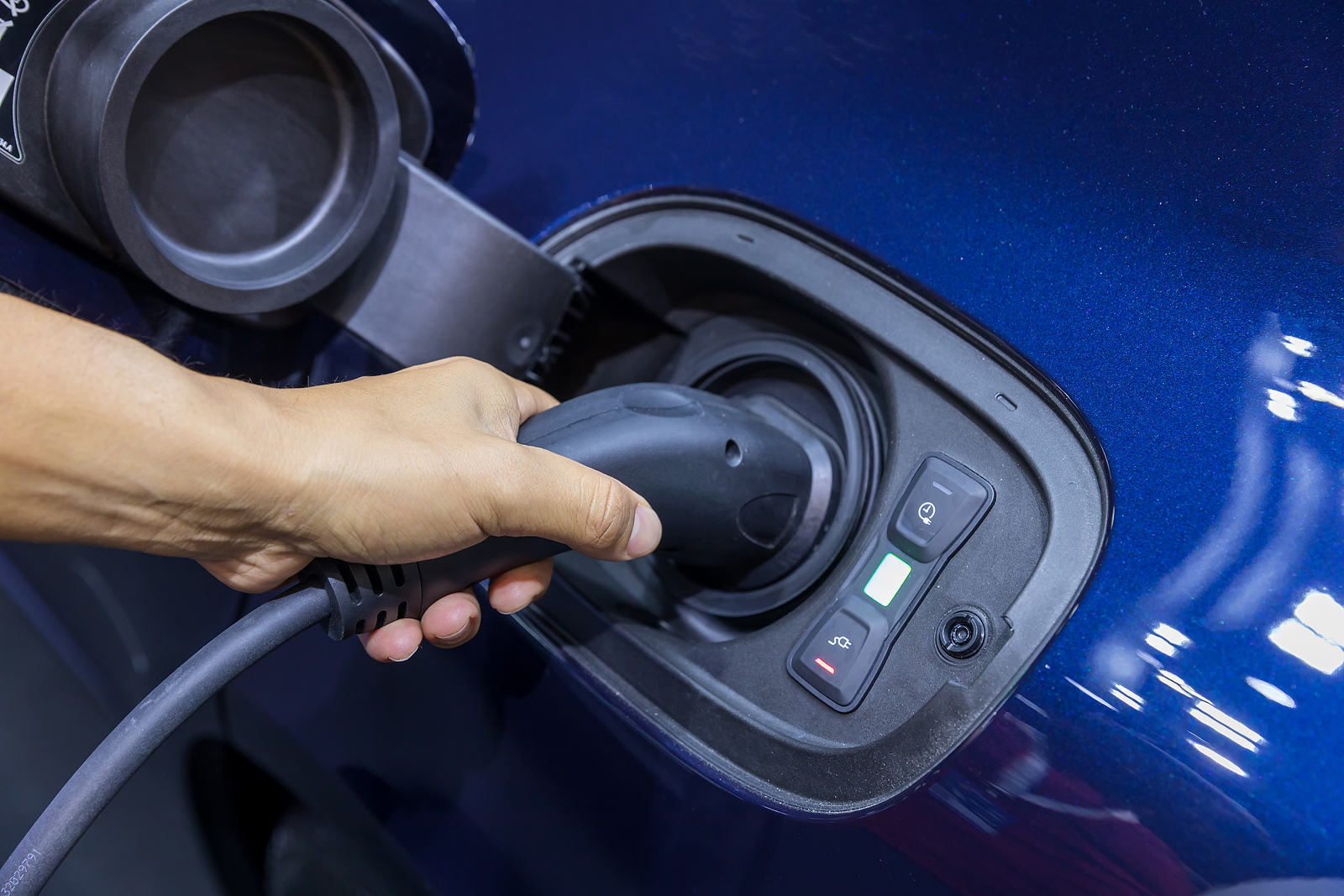 intensive electrician course - Hand holding Electric car charger