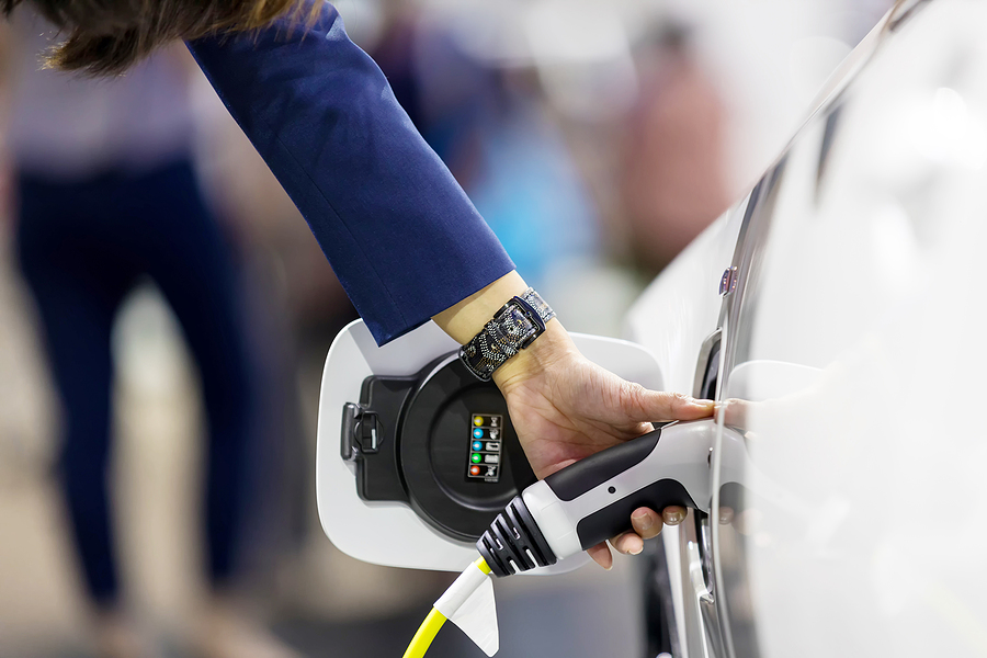 electrician courses - Hand holding Electric car charger