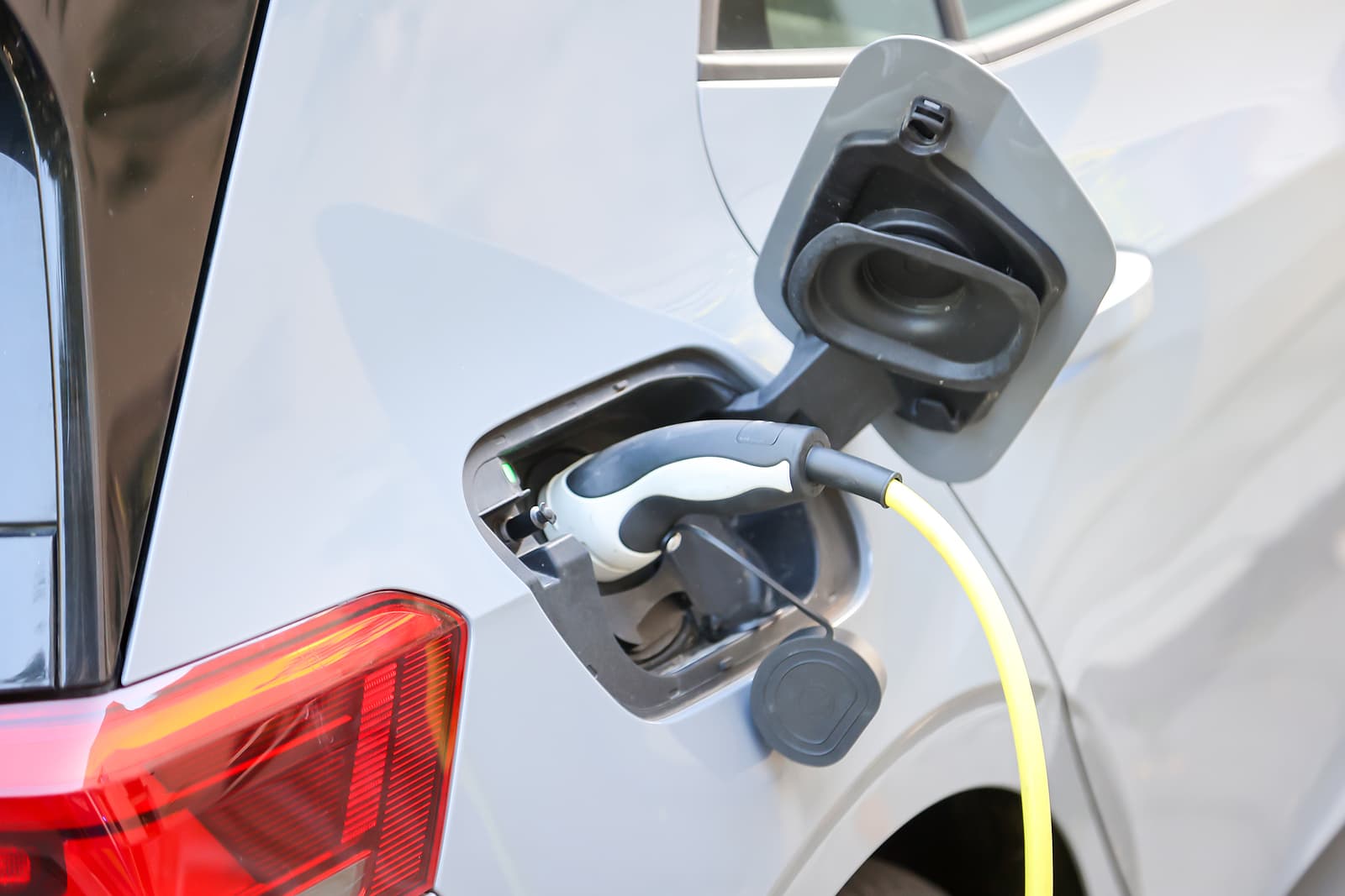 electrician courses manchester - electric car is charged at a charging station